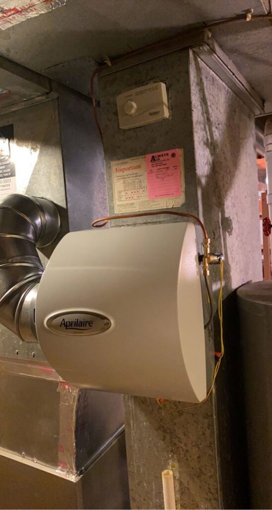 An Aprilaire whole-house humidifier installed on ductwork by JM HVAC Pros in Elgin, IL.
