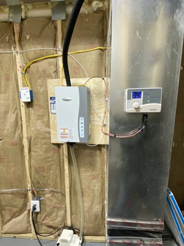An Aprilaire whole-house humidifier unit installed with ductwork by Infinite Heating & Air in Newnan, GA.