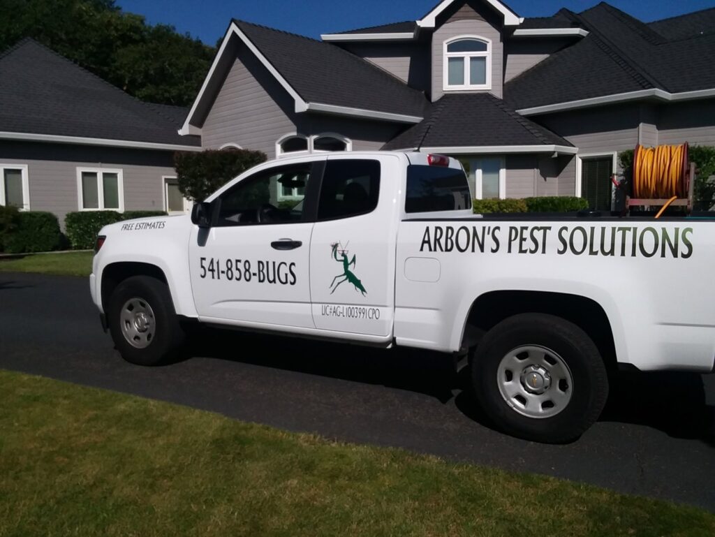 Arbon's Pest Solutions llc truck parked on a residential driveway, providing pest control services in Medford, OR.