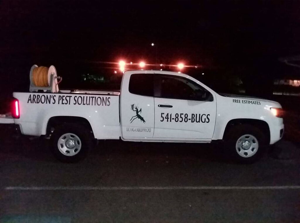 The Arbon's Pest Solutions llc service truck parked at a residential property for pest extermination in Medford, OR.