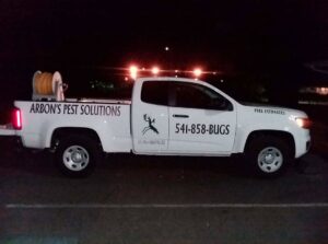 The Arbon's Pest Solutions llc service truck parked at a residential property for pest extermination in Medford, OR.