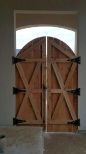 An arched wood double gate installed by A-1 Security Fence in Scott, LA.