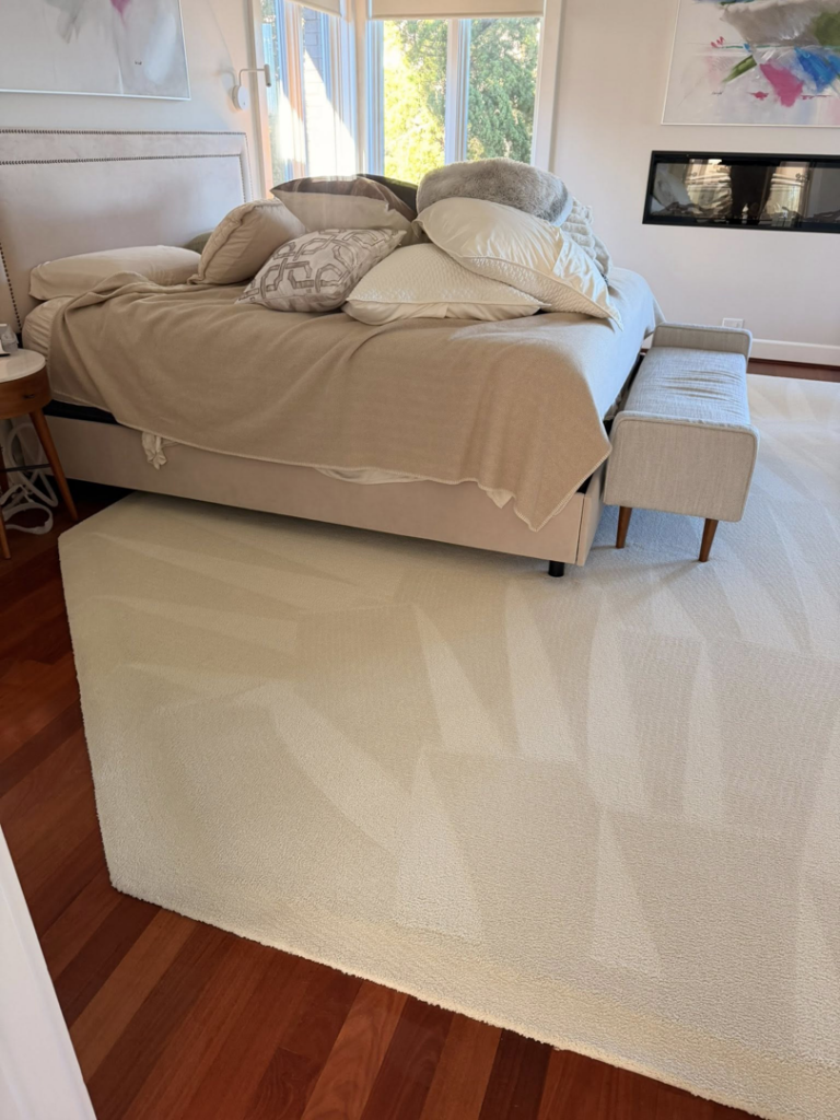 A light-colored area rug showing clear before and after cleaning results by First Response Custom Cleaning in Newport News, VA