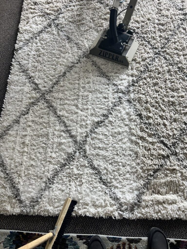 Professional area rug cleaning showing before and after results by Yellow Van Cleaning & Restoration in Kearney, NE