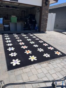 A colorful area rug laid out for cleaning or drying by Soap & Steam Carpet Cleaning in Raleigh, NC