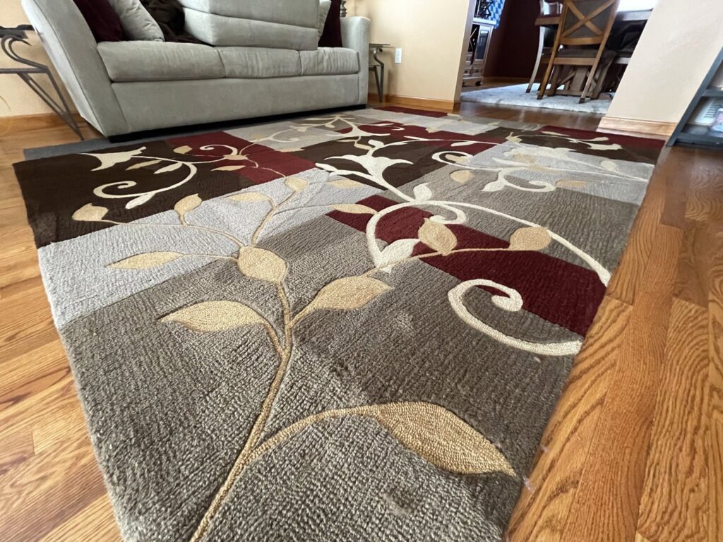A clean area rug on a hardwood floor after professional cleaning by Select Carpet Clean LLC in Scranton, PA.