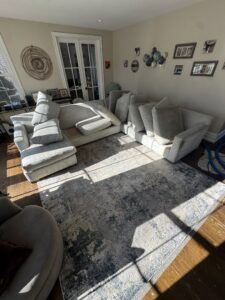 An area rug being cleaned with furniture moved aside by Tmz Magic Carpet Cleaning in West Hartford, CT.