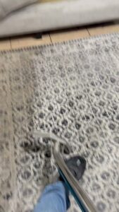 An area rug being professionally cleaned with a carpet cleaning wand by Superior Carpet Cleaning in Greenville, SC.