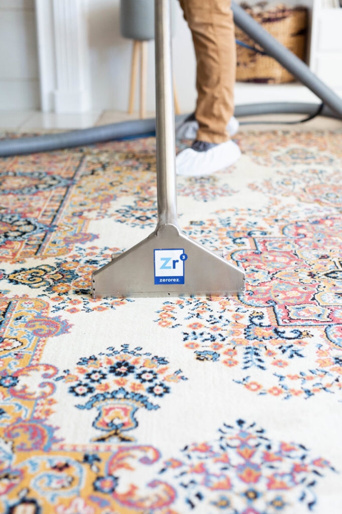 A Zerorez technician professionally cleaning an intricate area rug in Charlotte, NC.
