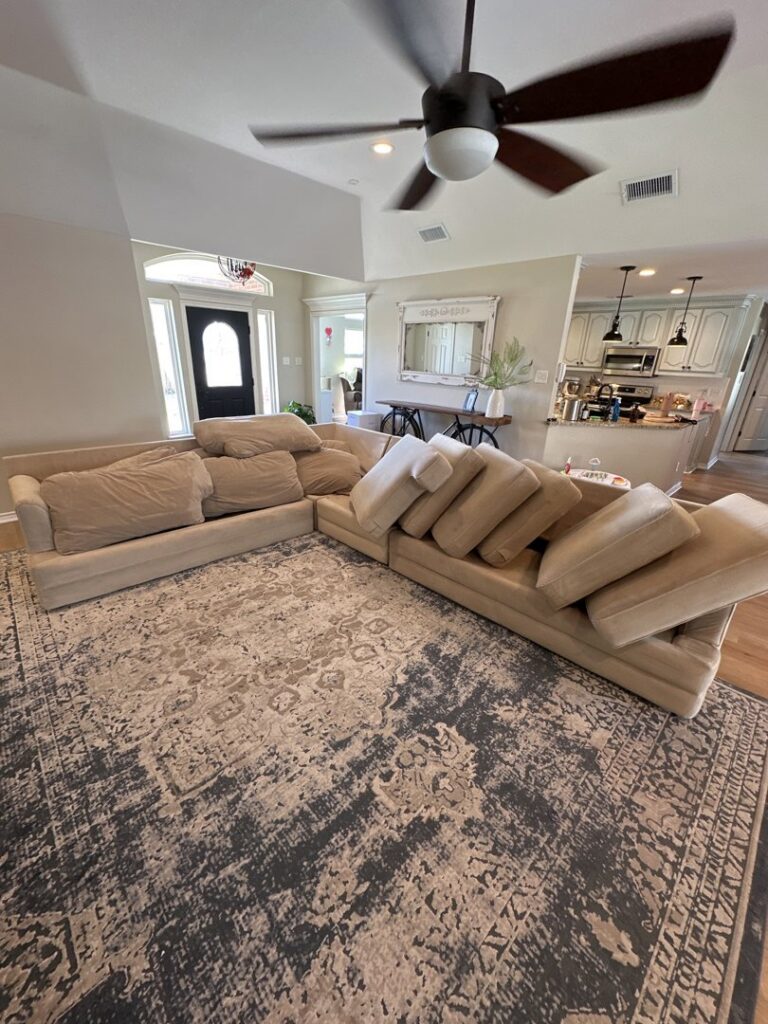 A large area rug prepared for cleaning in a living room by Coconut Cleaning of Dallas-Fort Worth in Dallas, TX.