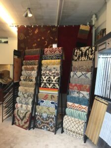 Display racks showcasing a wide selection of area rugs at Zakian Rug Cleaning in Philadelphia, PA