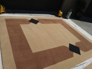 An area rug drying outdoors with fans after professional cleaning by My Dad's Floor and Upholstery Cleaning in Sacramento, CA.
