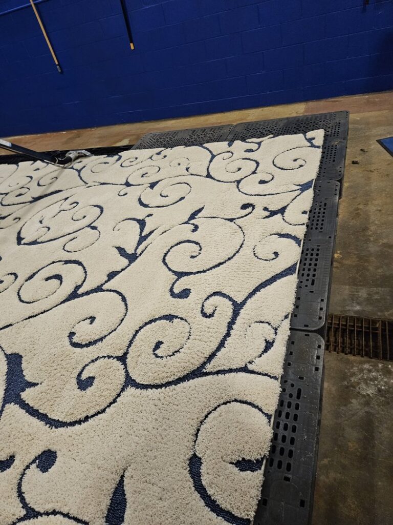 A patterned area rug drying on a rack after professional cleaning by BEST Professionals Cleaning, LLC in Lancaster, PA