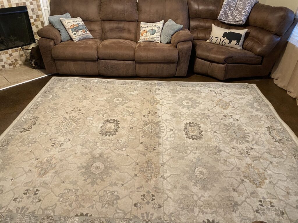 An area rug showing a clear before and after cleaning, half-cleaned by Stain Punishers Carpet Cleaning in Plano, TX.