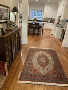 A patterned area rug placed on a wooden floor in a modern kitchen and dining area by Accents Galleria in Kansas City, MO
