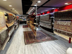 A wide selection of area rugs displayed in the showroom of Morency Flooring in New Bedford, MA.