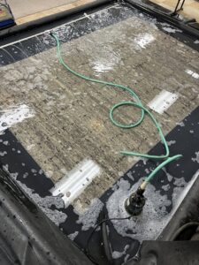 An area rug soaking in a cleaning tub during the deep cleaning process by All American Carpet & Tile in San Diego, CA