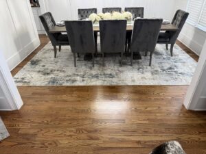 A stylish area rug placed under a dining table in a home, serviced by Advanced Cleaning Systems in Atlanta, GA.