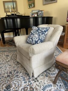 An ornate area rug and upholstered armchair in a living room, representing services provided by Yellow Finch Carpet Cleaning LLC in Dover, NH.