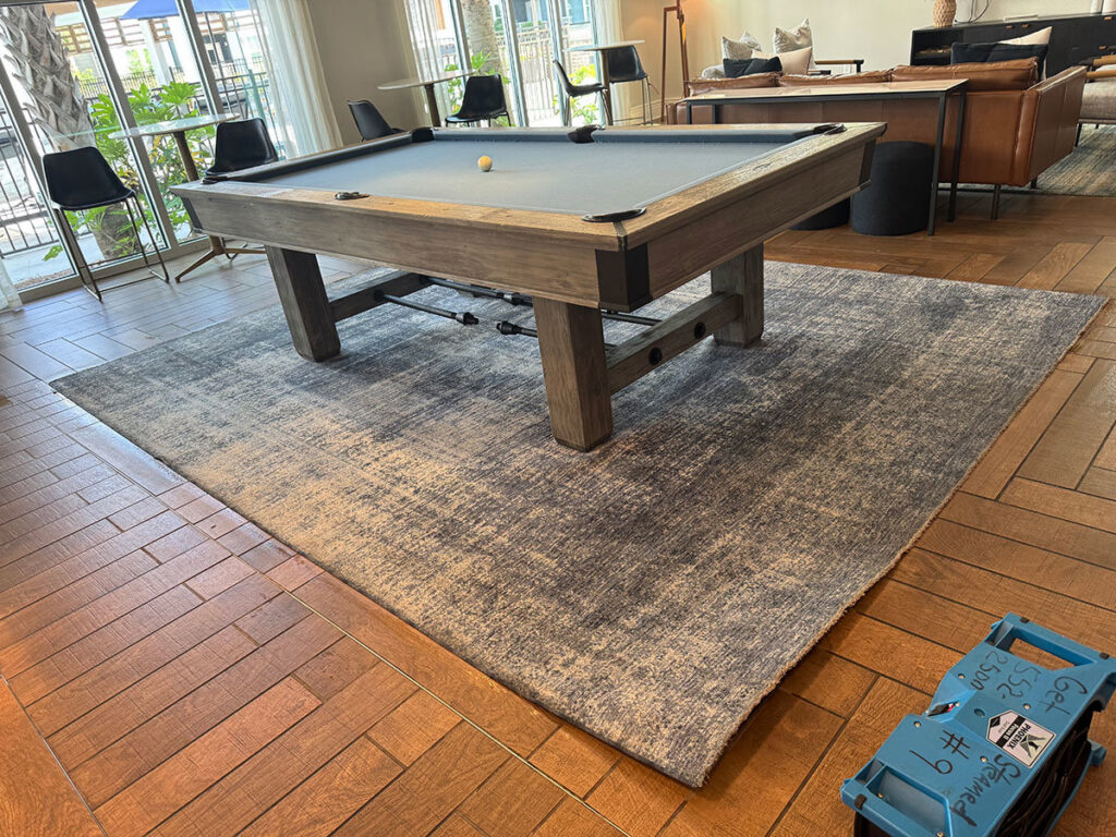 An area rug with a pool table and Get Steamed Carpet Cleaning, Inc. equipment in North Charleston, SC.