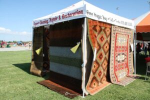 Two decorative area rugs placed on a wooden floor in a commercial setting by Ebie's Rug Cache & Ebie's Rug Cleaning in Tucson, AZ