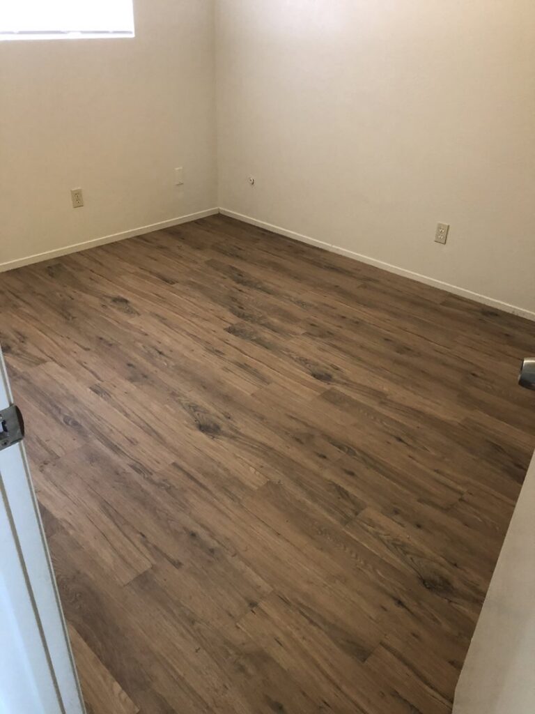 Several colorful area rugs laid out on a driveway, drying after professional cleaning by Superior Carpet Care in Fresno, CA.