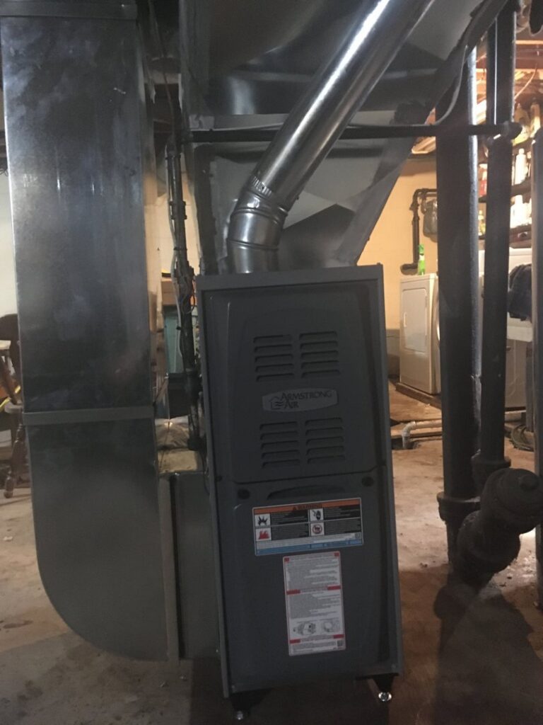 An Armstrong Air brand furnace and air handler unit with ductwork, installed by Adams Heating and Cooling in Schenectady, NY