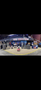 The Arrowhead Heating & Air Conditioning team at their trade show booth with HVAC units in Casper, WY.