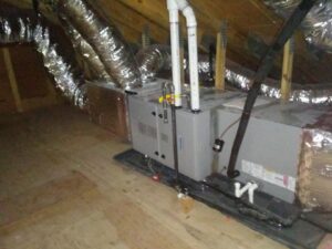 An air handler unit and insulated ductwork installed in an attic by Air We Are in Toms River, NJ.