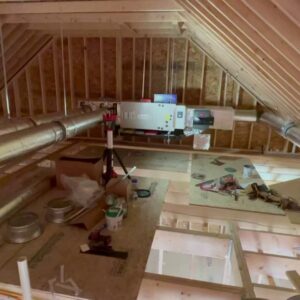 An indoor air handler unit and ductwork being installed in an attic by EML Mechanical in Boston, MA.