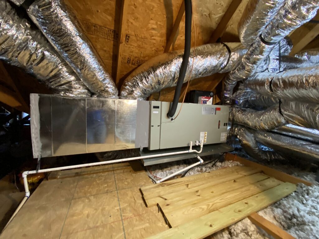 An indoor air handler and furnace unit with ductwork installed in an attic by Fort Worth Air Conditioning Co. Inc. in Fort Worth, TX.