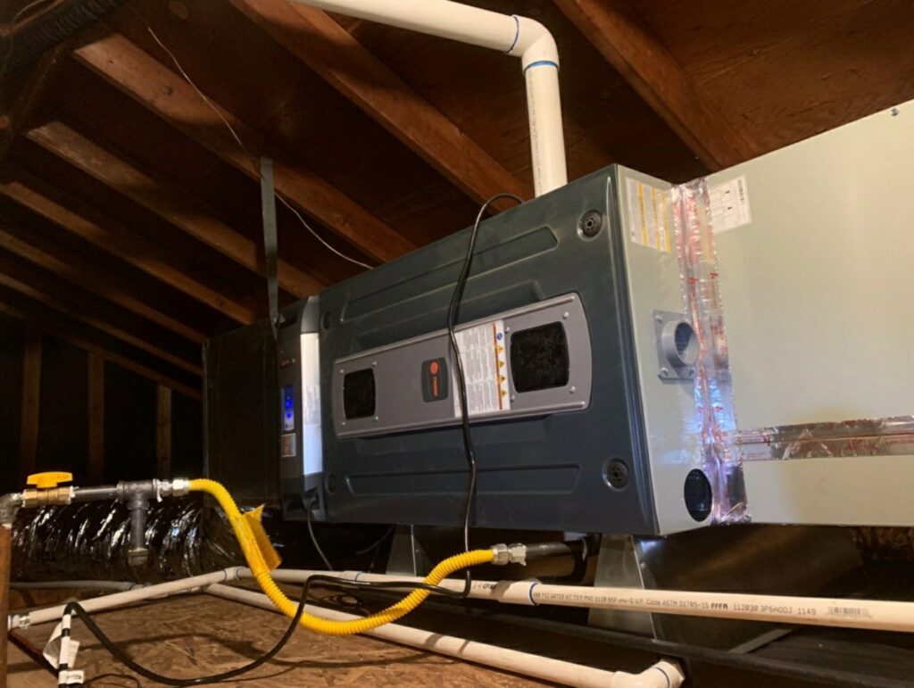 An indoor air handler or furnace unit installed in an attic with ductwork and gas lines by Ecology Air Innovations in Sacramento, CA.