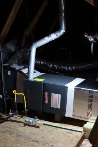 An air handler and furnace unit installed in an attic by Manuel & Sons Service Co. in San Antonio, TX.