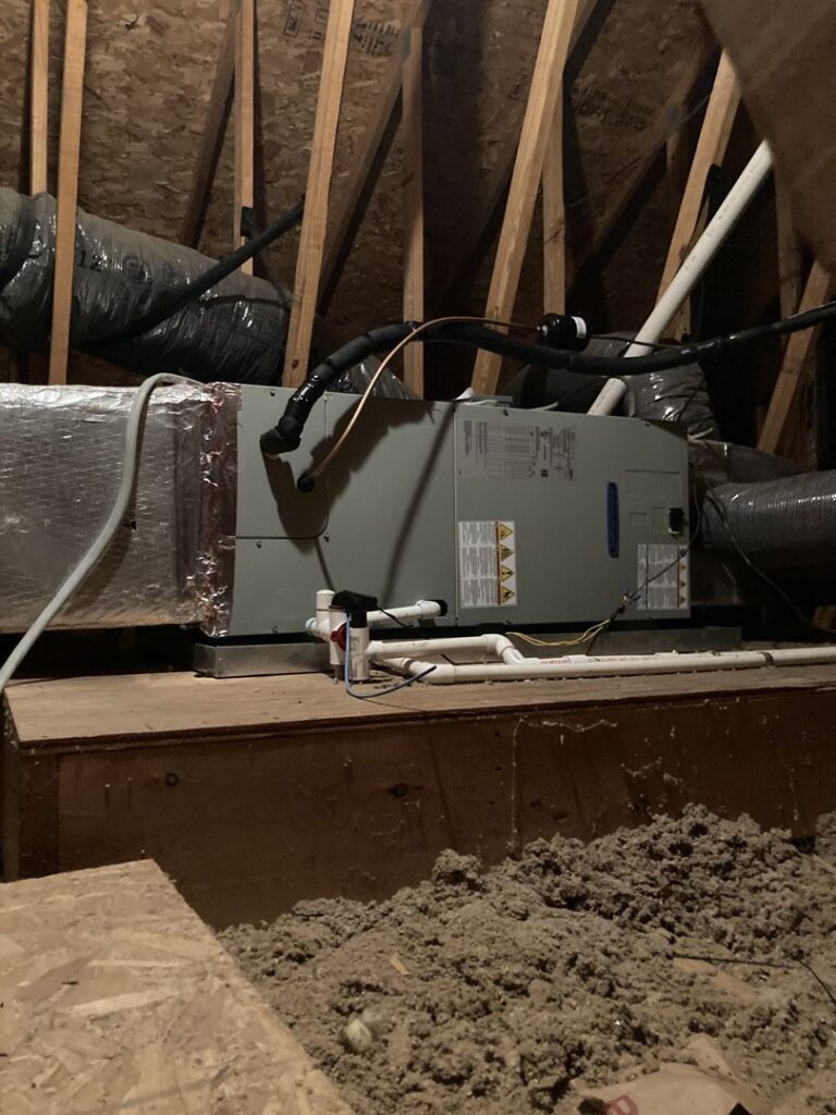 An air handler or furnace unit with ductwork installed in an attic space by Tack Mechanical LLC in Baltimore, MD.