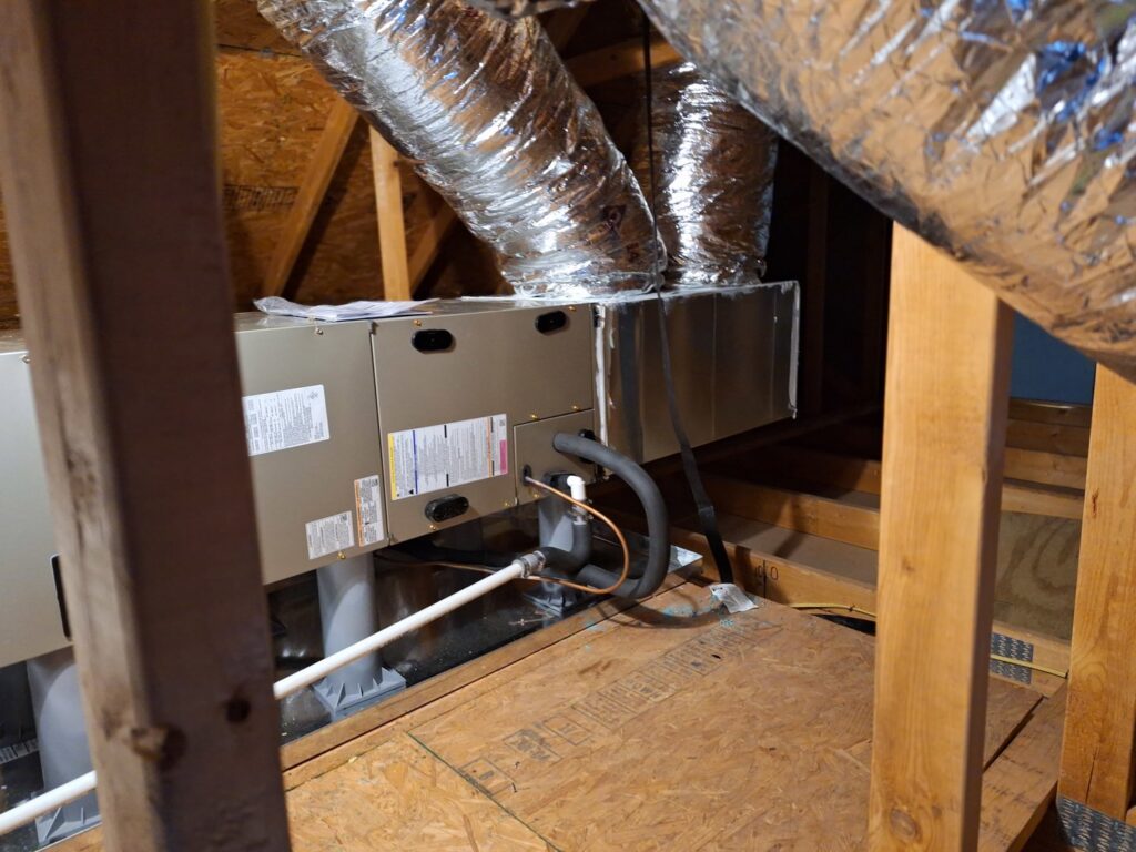 An indoor air handler or furnace unit installed in an attic with ductwork by The Right Flow Heating and Air LLC in Lawton, OK