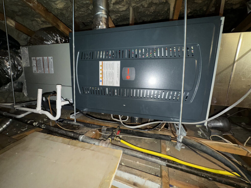 An air handler unit installed in an attic space with ductwork and wiring by Az AC and Heat Services in Queen Creek, AZ.