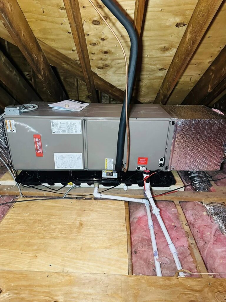 An indoor air handler or furnace unit installed in an attic with ductwork by Deboque Duct Design Corp. in Staten Island, NY