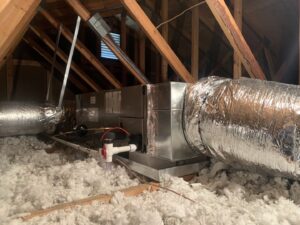 An air handler unit with ductwork installed in an attic with insulation by Air Energy Solutions in North Chesterfield, VA