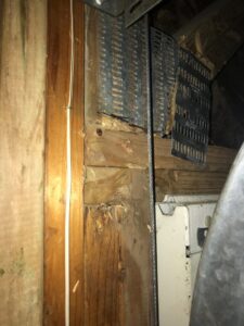 An inspection of wooden beams and metal grating in an attic or crawl space by Rose Extermination Co. in Imperial, MO.