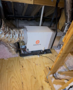 A Santa Fe whole-home dehumidifier unit installed in an attic, connected to HVAC ductwork by Gibson's Air Conditioning & Heating in Corpus Christi, TX.