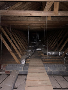 Flexible ductwork installed in an attic space, demonstrating HVAC installation services by Comfy Cool HVACR in Newport News, VA.