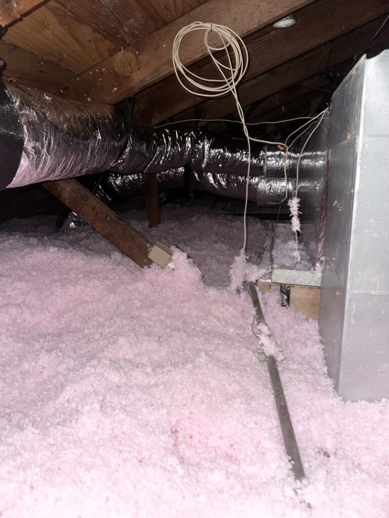 Attic space with flexible ductwork and insulation, showcasing HVAC infrastructure by Grand Slam Heating & Air in Baton Rouge, LA.