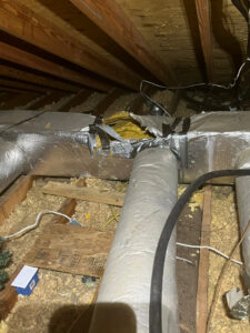 HVAC ductwork in an attic, showing insulation and repairs, handled by Climate Mechanical in Dinwiddie, VA.