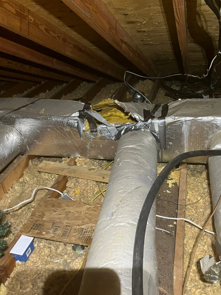 HVAC ductwork in an attic, showing insulation and repairs, handled by Climate Mechanical in Dinwiddie, VA.