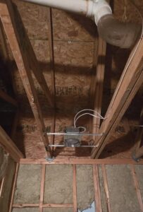 An electrical junction box with conduit and wiring installed in an attic space by Innovate Electric in Earth City, MO.
