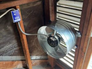 An attic fan with its control box and wiring, installed by Decatur Electrician Now in Decatur, AL.