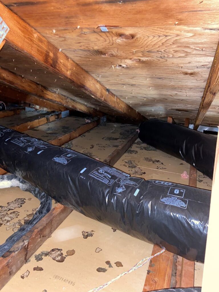 Flexible HVAC ductwork installed in an attic, a service provided by Service Legends in Des Moines, IA.