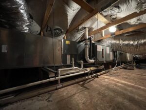 An installed HVAC air handler and ductwork system in an attic by Blue Collar HVAC in Henderson, NV.
