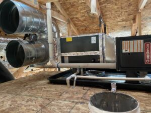 An HVAC air handler unit and extensive ductwork installed in an attic during new construction by Integrity Heating And Air LLC in Nampa, ID