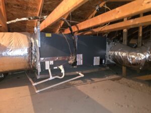 An attic HVAC air handler unit with extensive ductwork installation by Krahn and Son Mechanical in Glendale, AZ.